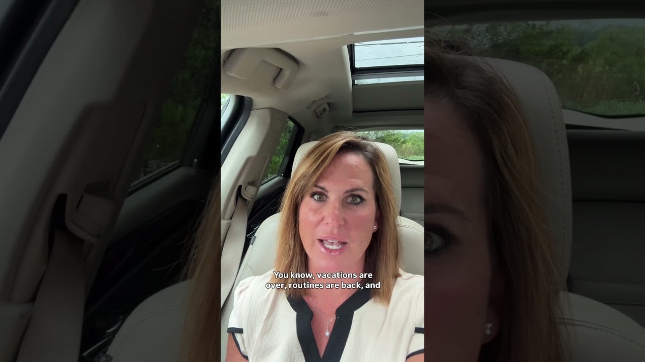 Woman speaking to camera from a car’s front seat, with a sunroof overhead.