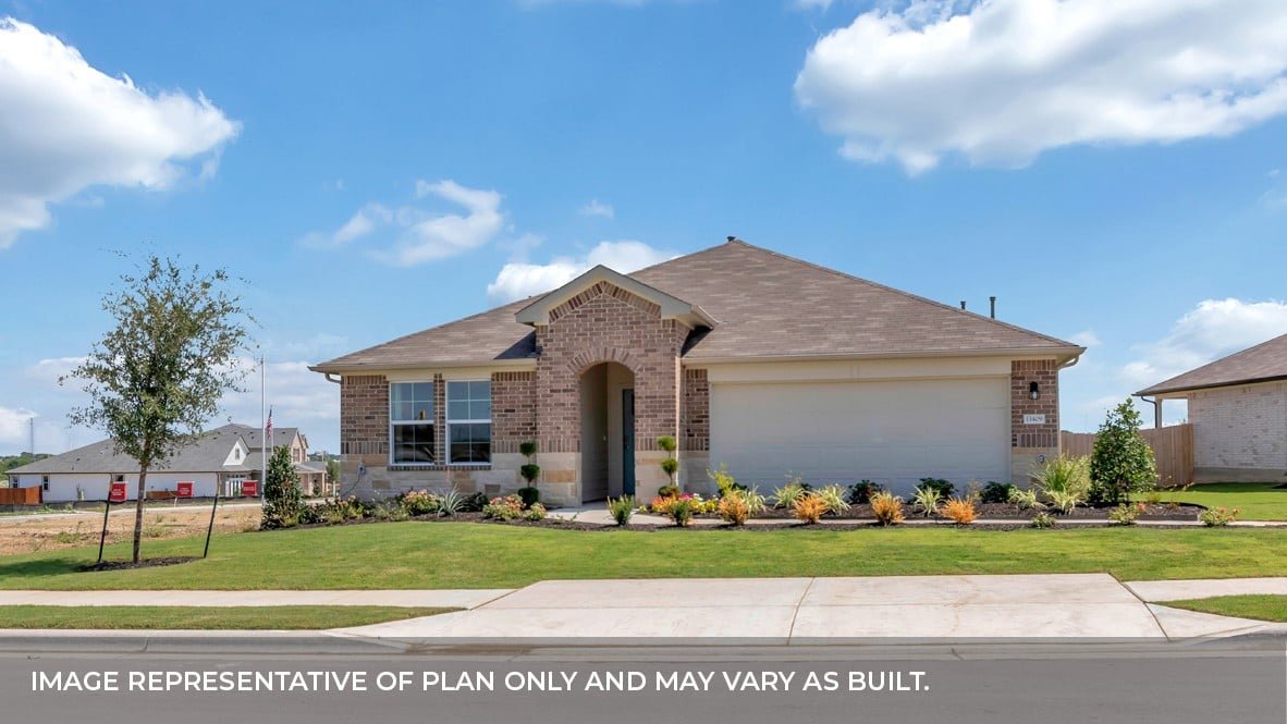 Brick house with an arched entry, attached garage, and landscaped front lawn.