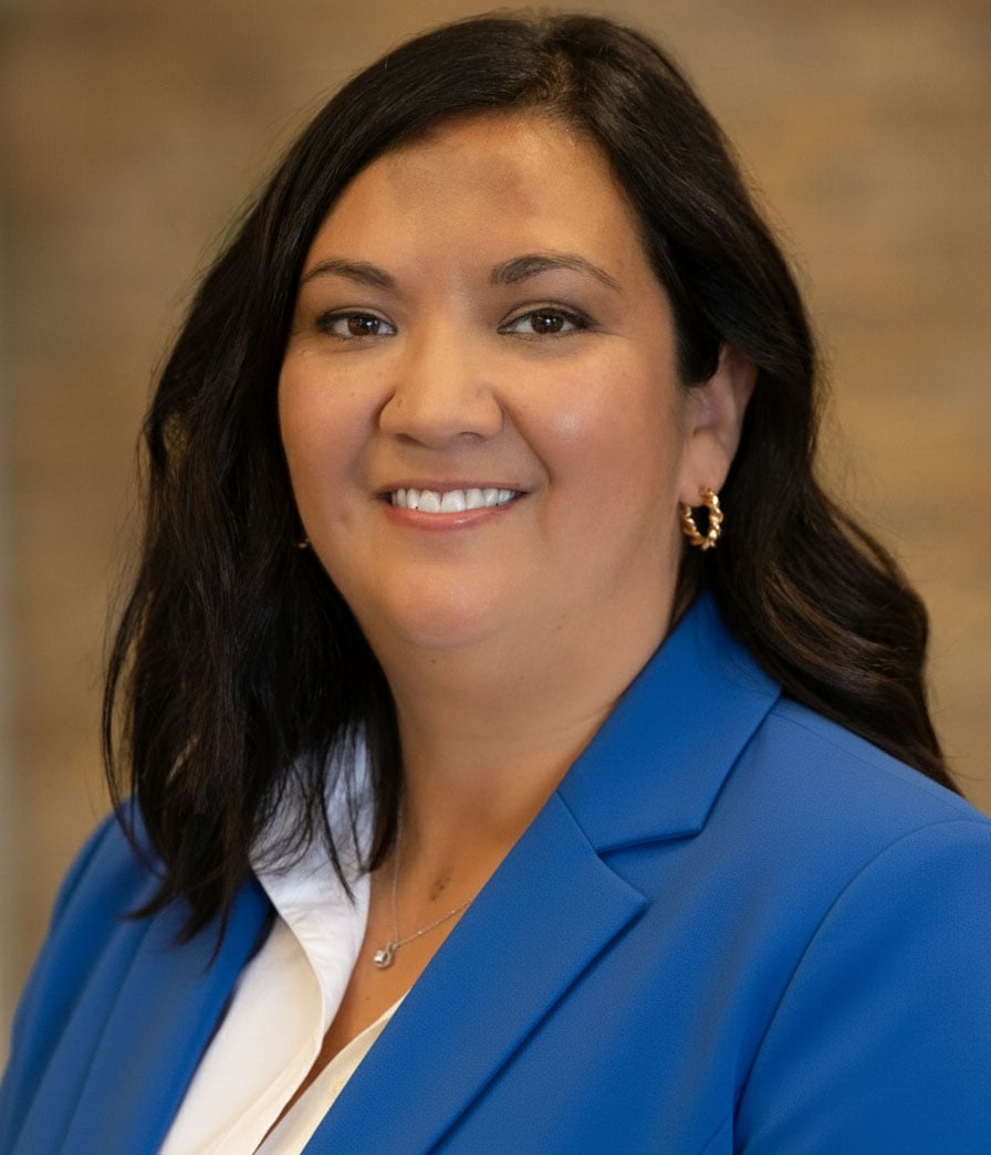 Jennifer Moughanni smiling in a blue blazer and white blouse.