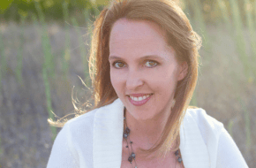 Tracy in field at golden hour in white shirt