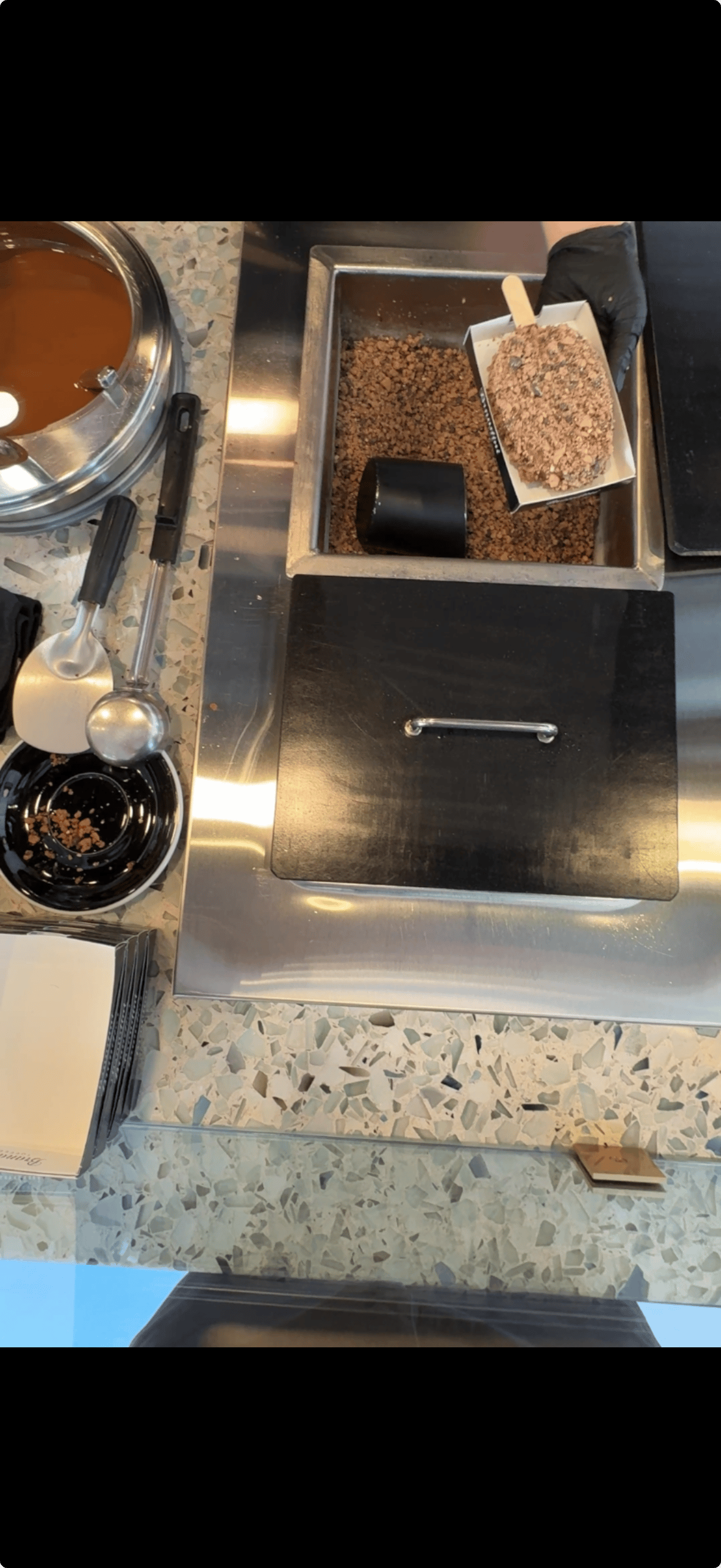 Coffee, ice cream, and toffee menus above the counter at Brandini Toffee in Palm Springs