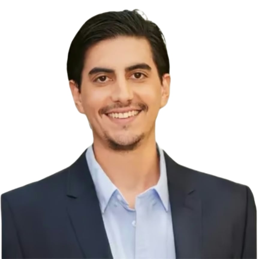 Manuel Del Nido smiling in a dark suit jacket and light blue shirt