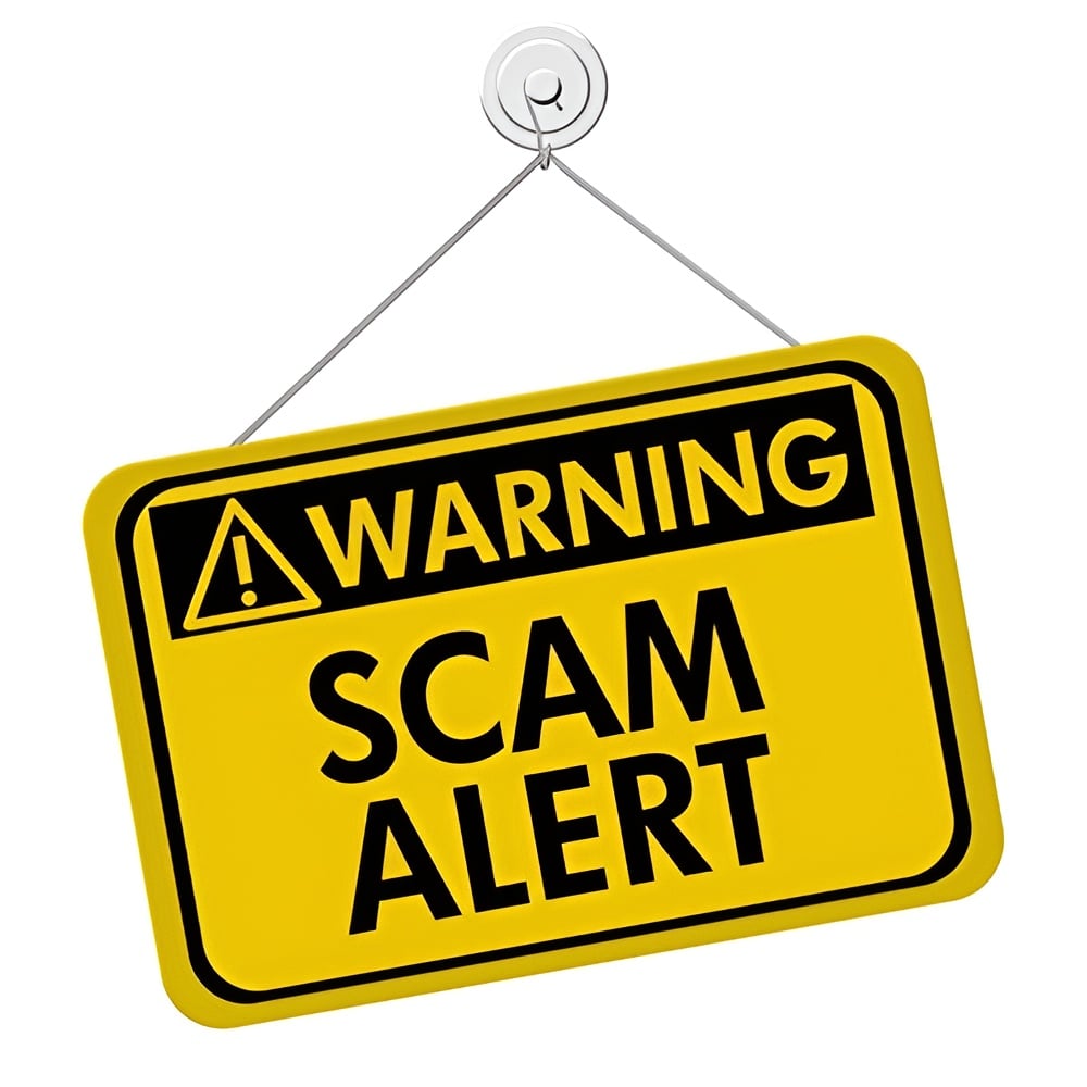 Yellow warning sign reading “SCAM ALERT” with a triangular exclamation symbol.