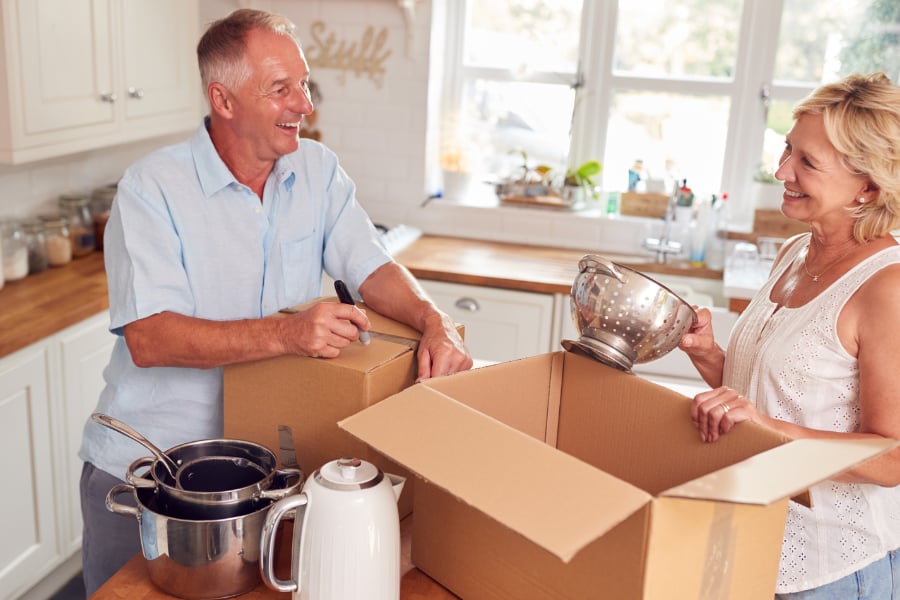 People packing their kitchen to downsize