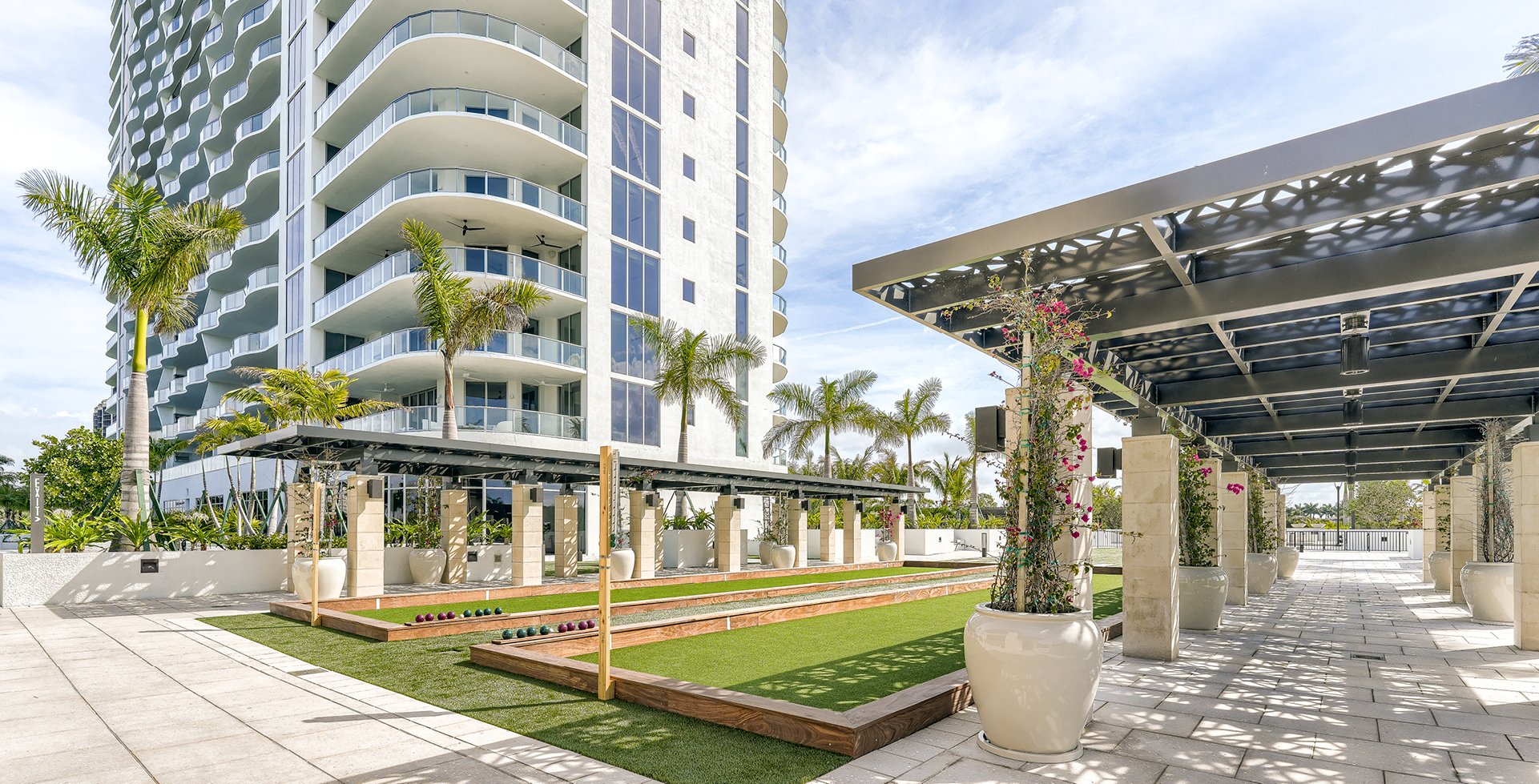 Infinity at The Colony tower above its lawns and outdoor courts