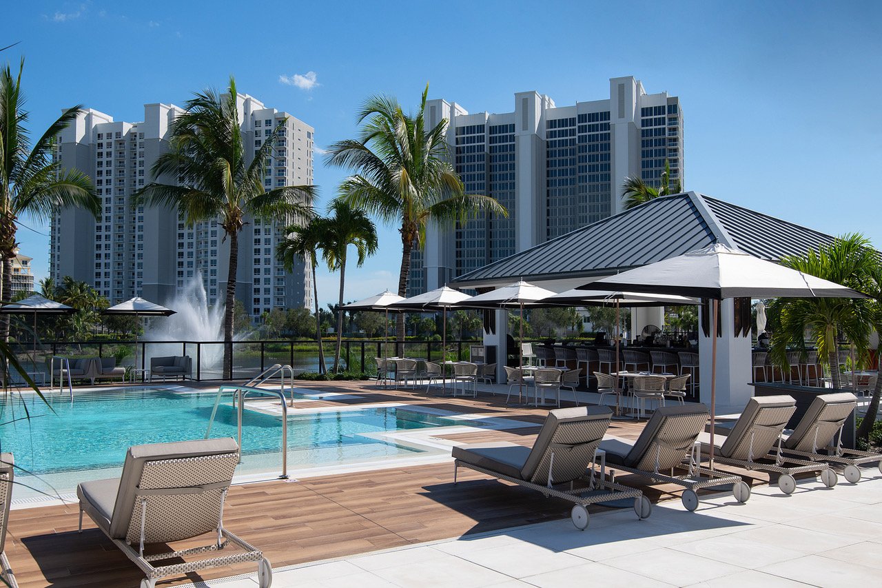 Pool deck with lounge chairs and the Kalea Bay towers beyond