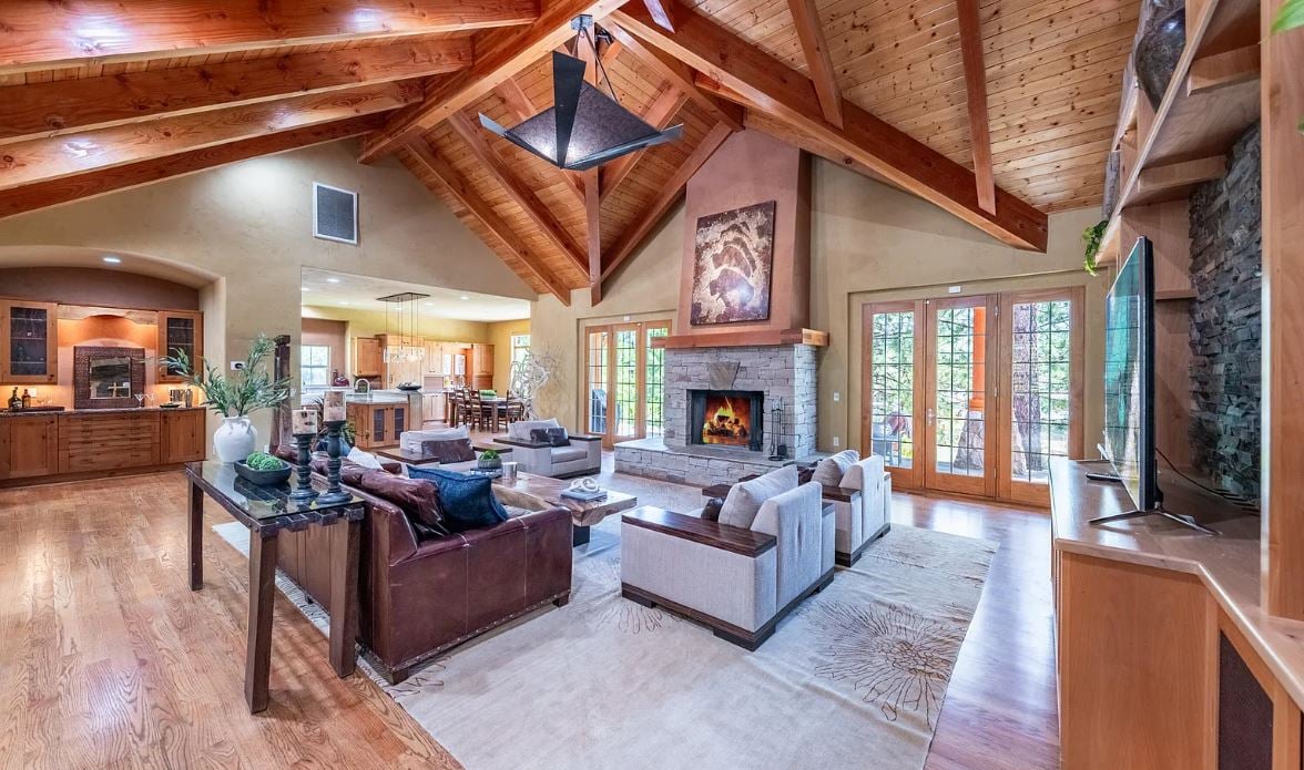 Nestled within the exclusive and rarely available gated community of Rosecreek, this extraordinary single-story custom home is perfectly situated on a lush and private 1.24-acre lot in Galena Forest. Backing onto the Montreux neighborhood, at the tranquil end of a picturesque cul-de-sac, this property offers an unparalleled living experience immersed in serene pine forests.  Step through the grand entrance and discover an impressive open-concept layout designed to seamlessly blend indoor luxury with outdoor living. Perfectly crafted for entertaining, the expansive living spaces include a generous family room featuring a striking wood-burning fireplace, and a sophisticated dining and game room, complete with a tempered wine room and chic bar area.