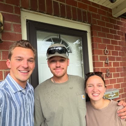Aaron with clients outside their home
