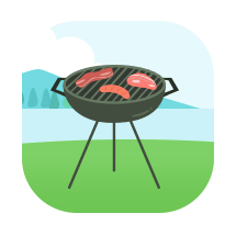 Charcoal kettle grill with food cooking on the grate in a grassy yard.