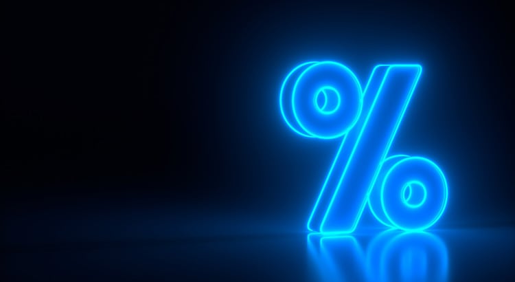 Glowing blue percent sign reflected on a dark surface.