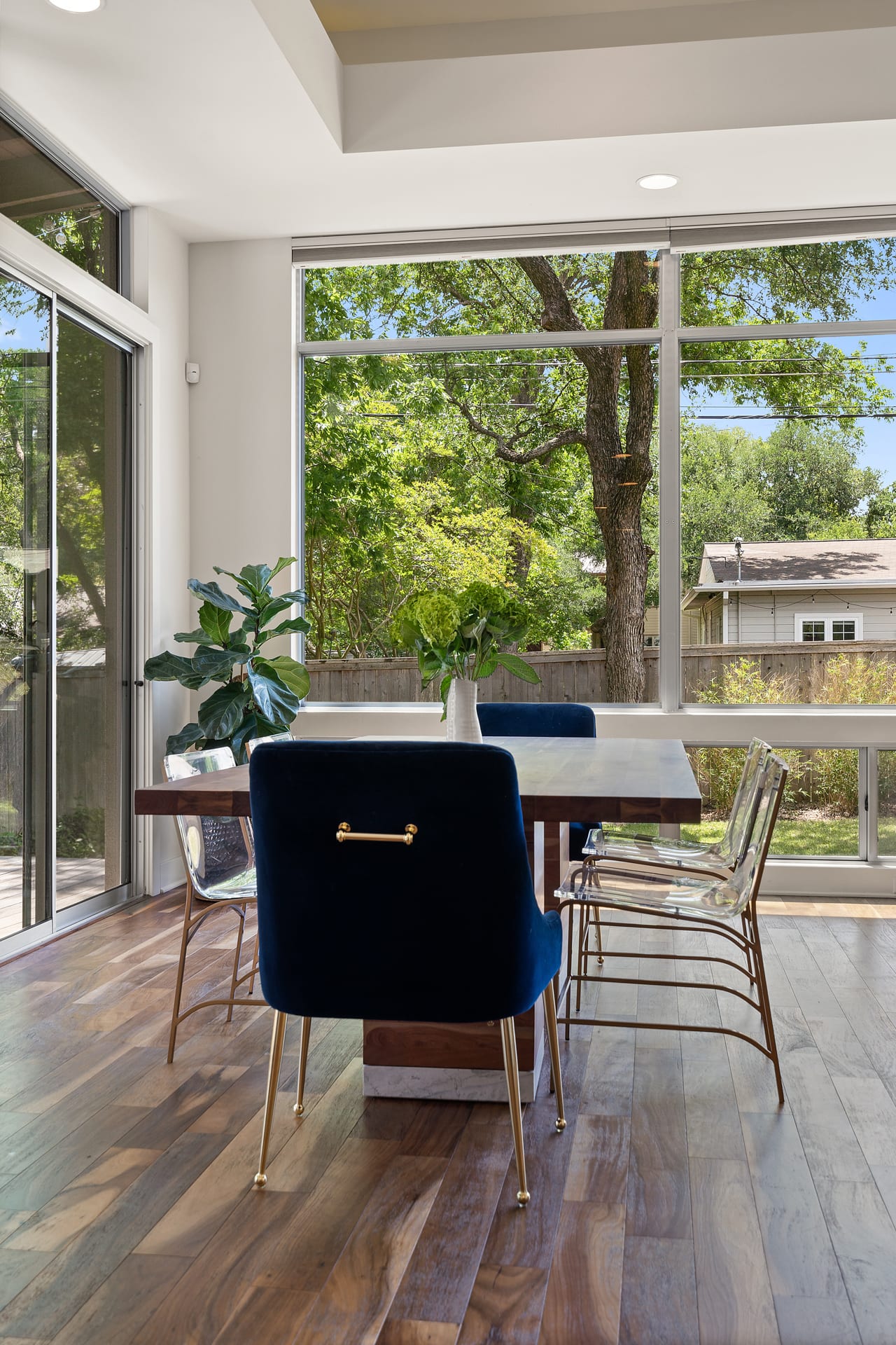 Dining room with a wall of windows and hardwood floors at 34 Margranita Crescent, Tarrytown, Austin, TX.