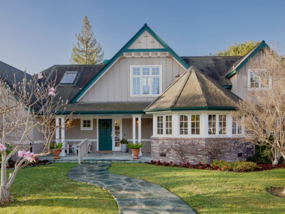 Front exterior of a Craftsman-style home with a landscaped front yard and covered porch in Menlo Park, California.