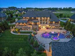 Aerial view of an expansive luxury estate in The Summit featuring a custom swimming pool and lush landscaping, showcasing high-end living in El Dorado Hills.