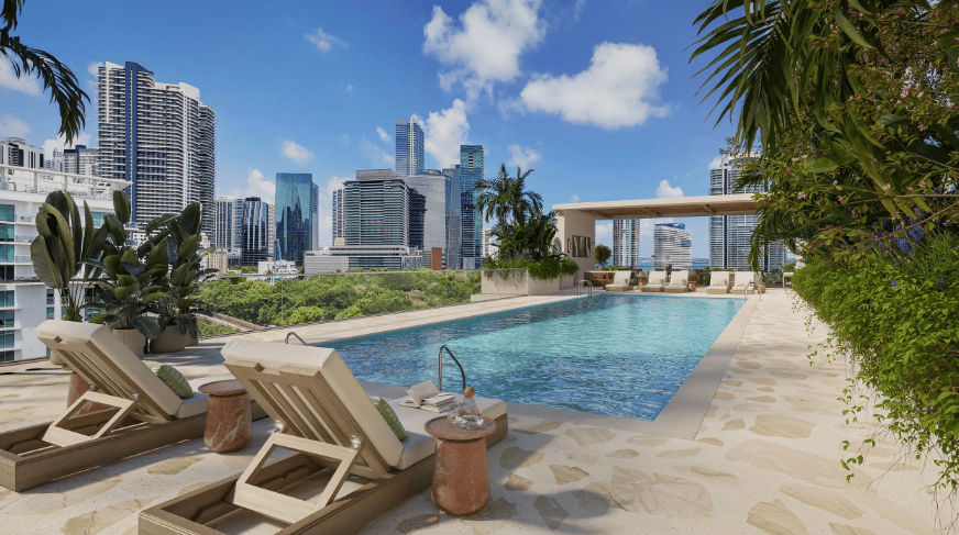 Rooftop pool deck with lounge chairs and Miami skyline views.