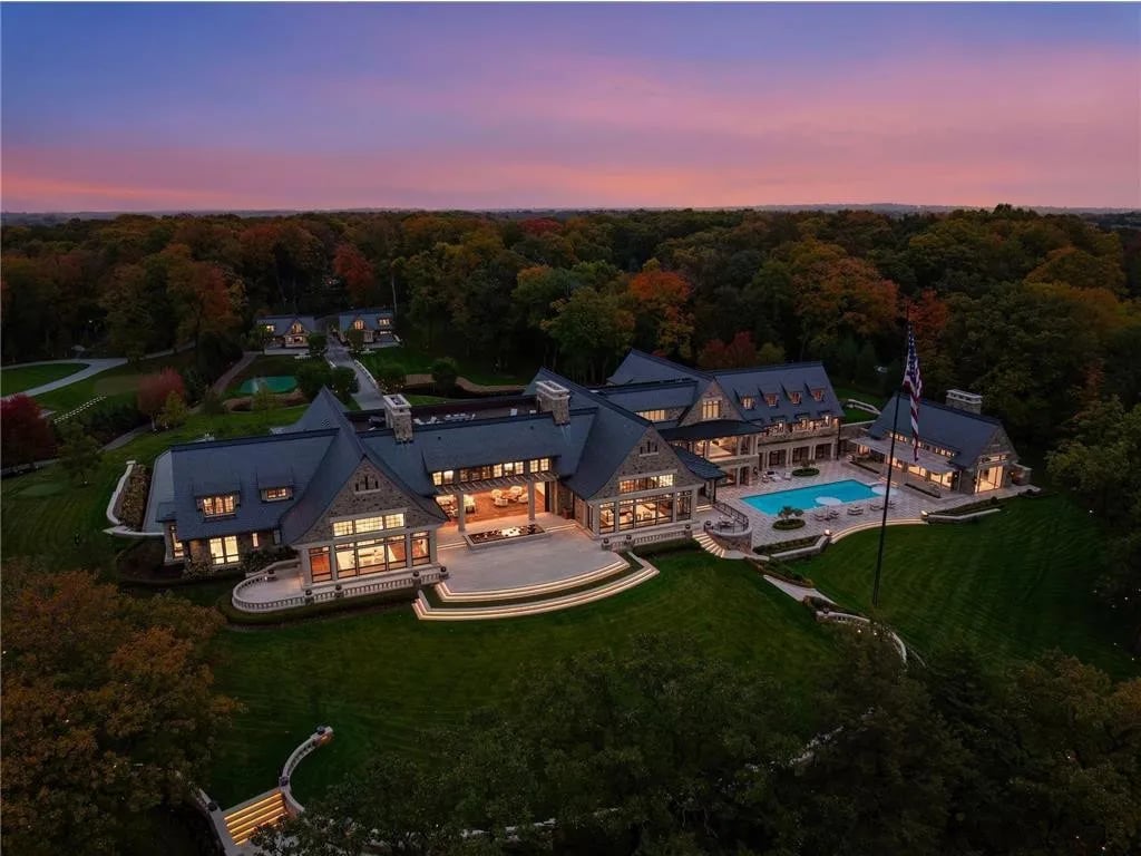 Luxury home on 6.12 private acres in Medina, Minnesota featuring a three-car garage, expansive driveway, and mature trees surrounding the property.