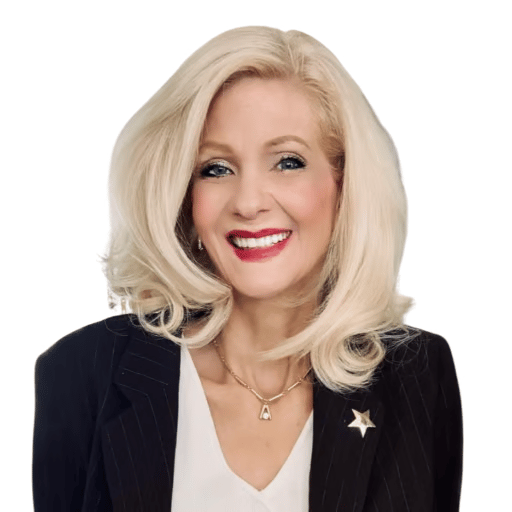 Elizabeth Garth smiling in a dark pinstripe blazer with a star-shaped lapel pin.