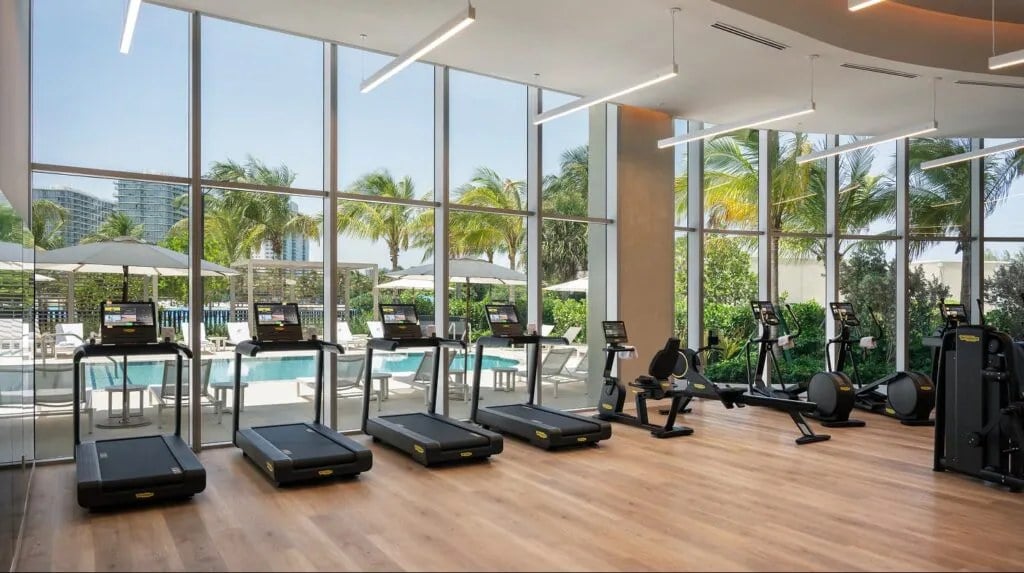 ONE Park Tower fitness center with cardio equipment and pool views.
