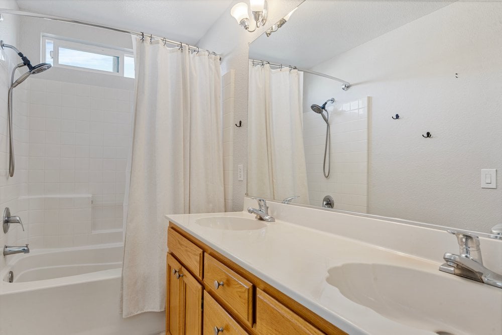 Bathroom featuring dual-sink vanity and bright lighting