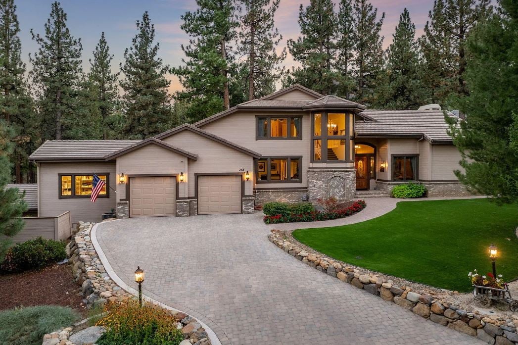 Welcome to your gorgeous custom home situated on over 2 acres of beautifully maintained, forested land. Designed for comfort and practicality, this property features a separate driveway leading to an oversized RV garage, ideal for extra storage or adventure gear.