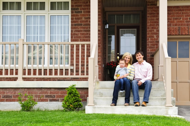 Happy Family on Front Steps of their Home