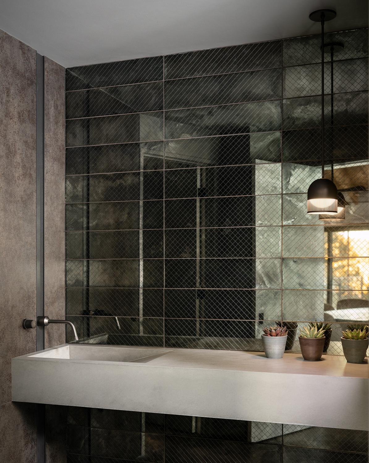 Modern Boulder bathroom featuring concrete sink, wire-glass wall panels, and pendant lighting