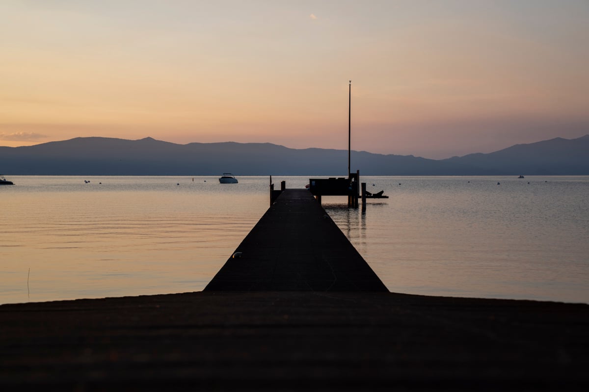 Pier at golden hour with calm water