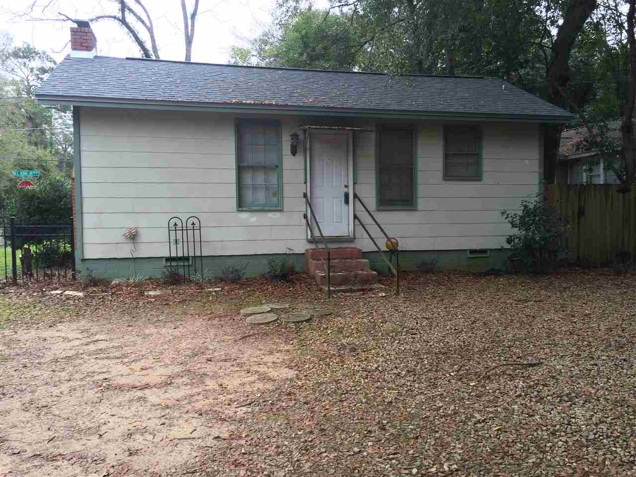 A small house featuring a welcoming front porch and a well-maintained yard.