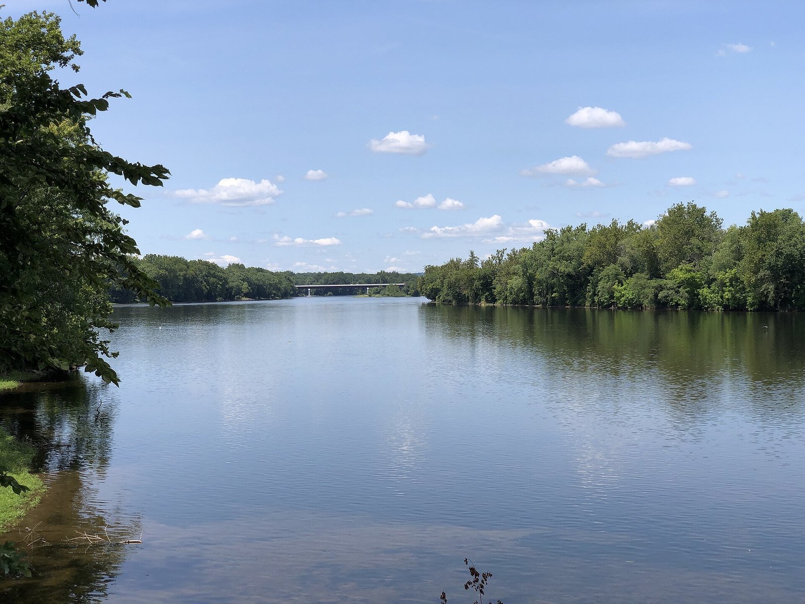 The Delaware River under a blue summer sky, seen from the Yardley riverfront