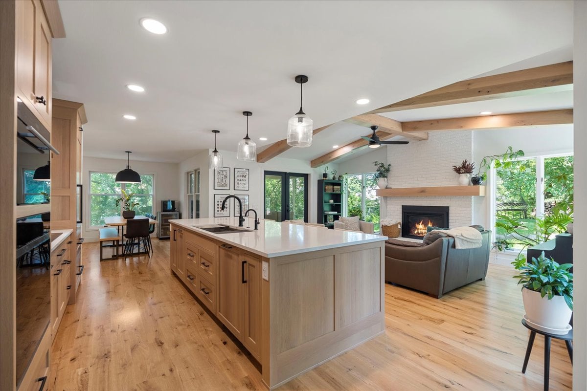 Remodeled kitchen in Madison WI home featuring large island, white oak cabinets, and luxury appliances