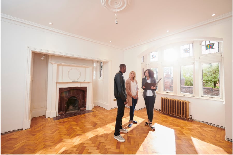 Couple looking apprehensive while touring a house