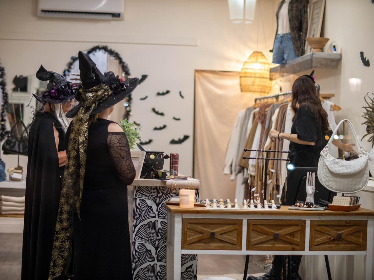 two women dressed as witches shopping during the livermore October halloween event witches night out in Downtown Livermore