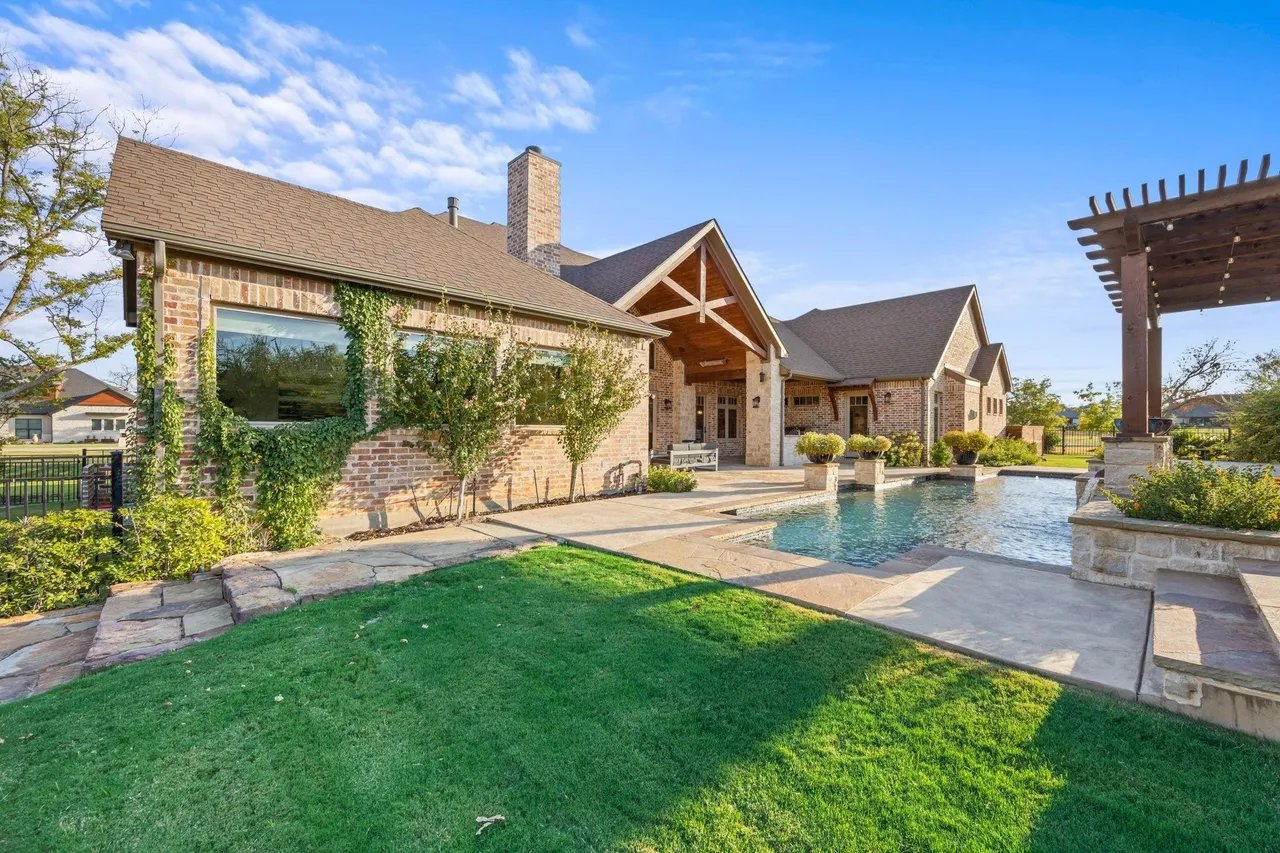 Luxury home with pool in Copper Creek Estates Copper Canyon TX with large backyard and outdoor living space.