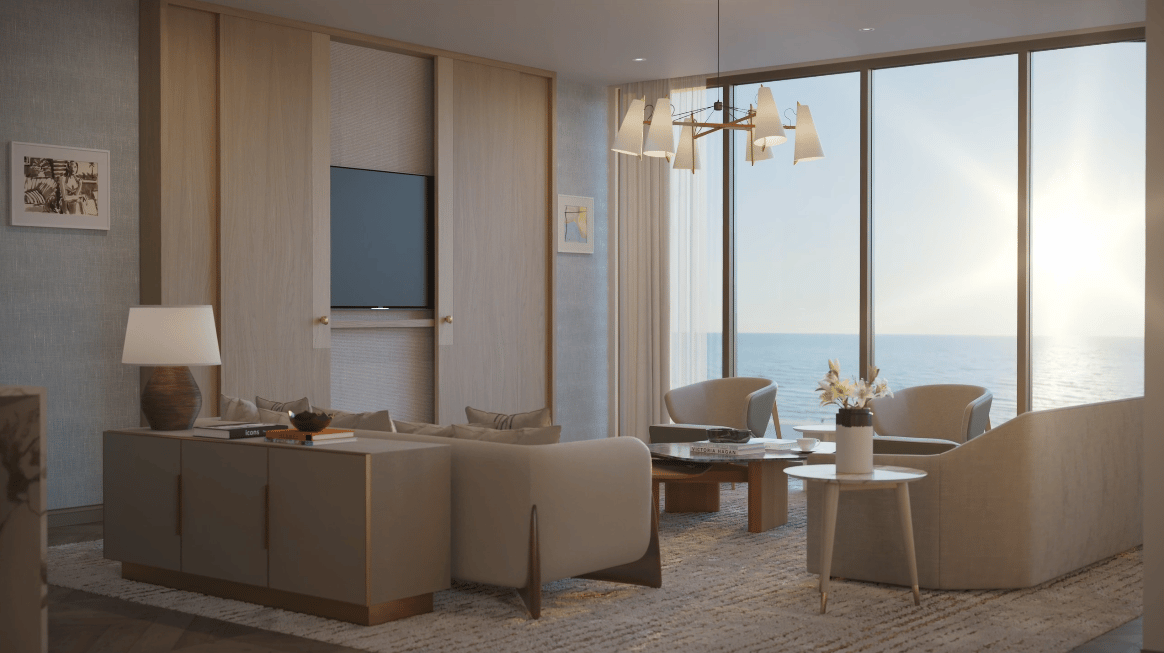 Luxury living room with neutral furnishings and floor-to-ceiling ocean-view windows.