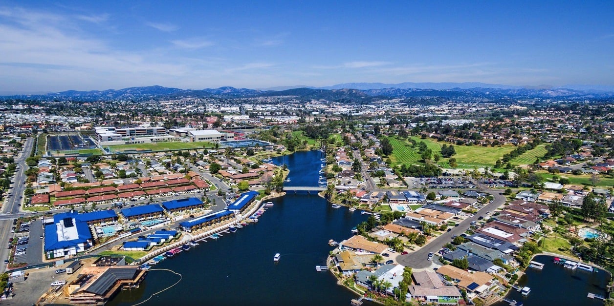 Aerial view of a lakefront neighborhood, with marinas, homes, and a golf course.