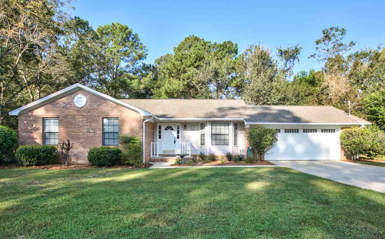 A spacious home surrounded by a large, well-maintained yard, showcasing greenery and open space.