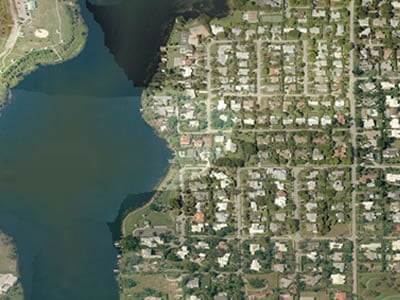 Aerial view of Lake Ida bordered by homes and streets.