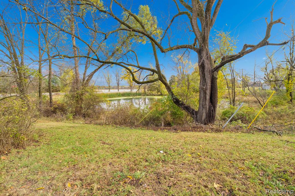 Backyard of the 4-bedroom home for sale at 13278 9 Mile Road, South Lyon, MI,