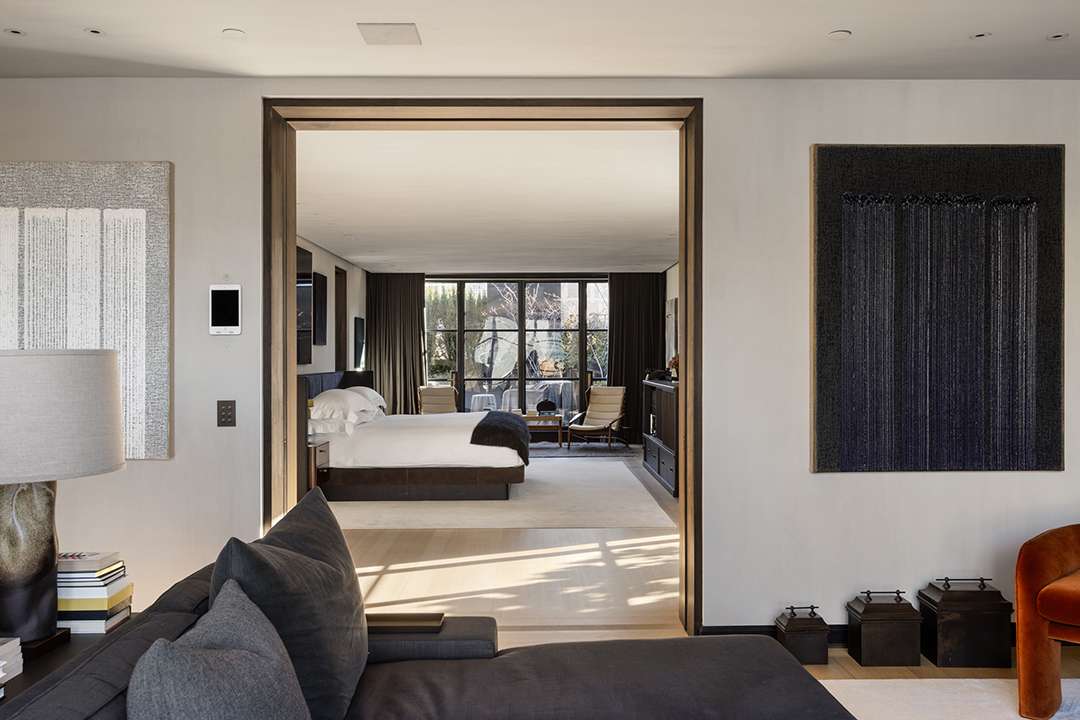 Master bedroom suite with minimalist design and private terrace access in the $45M SoHo penthouse, featuring Axel Vervoordt interiors and skyline exposure, shared by Brendan Brown Real Estate.