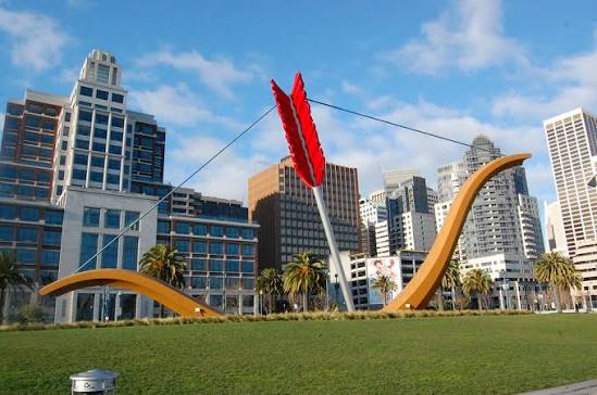 Cupid's Span bow and arrow sculpture with San Francisco skyline along the Embarcadero