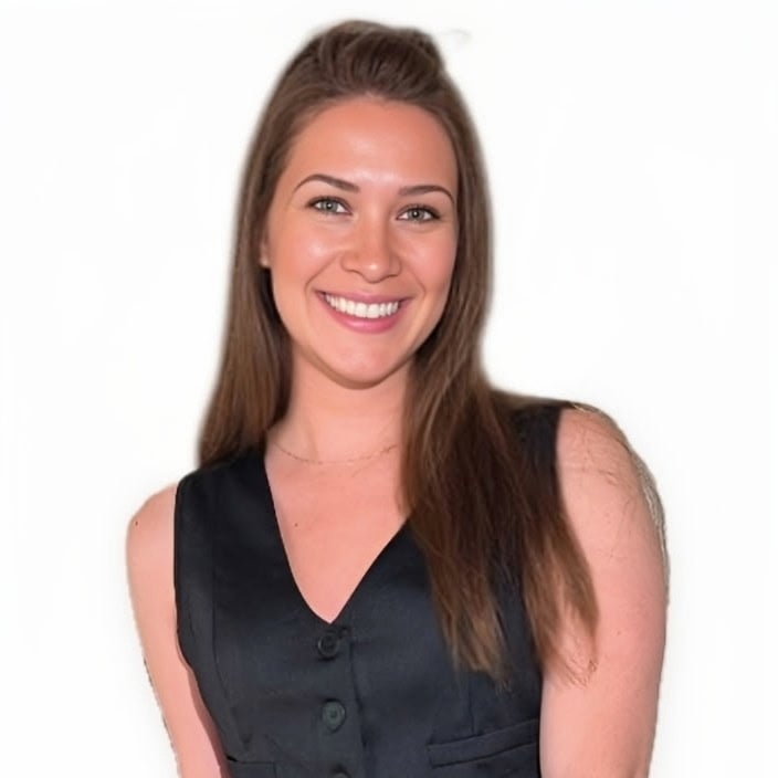 Francesca Hagen smiling in a black sleeveless vest.