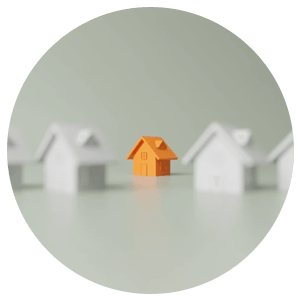 Orange model house in focus between two blurred white houses