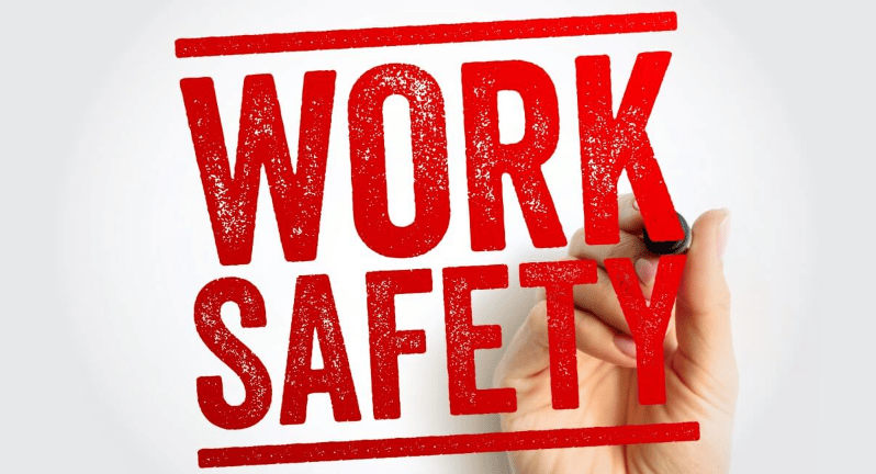 Work safety lettering beside a hand holding a marker.