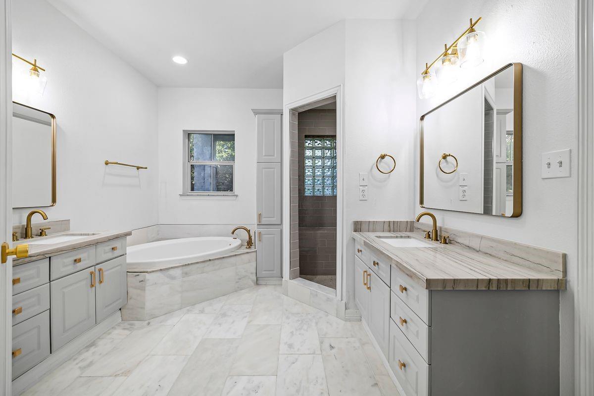 Primary bath with marble-look tile and dual vanity, Barton Hollow, Westlake, Austin.