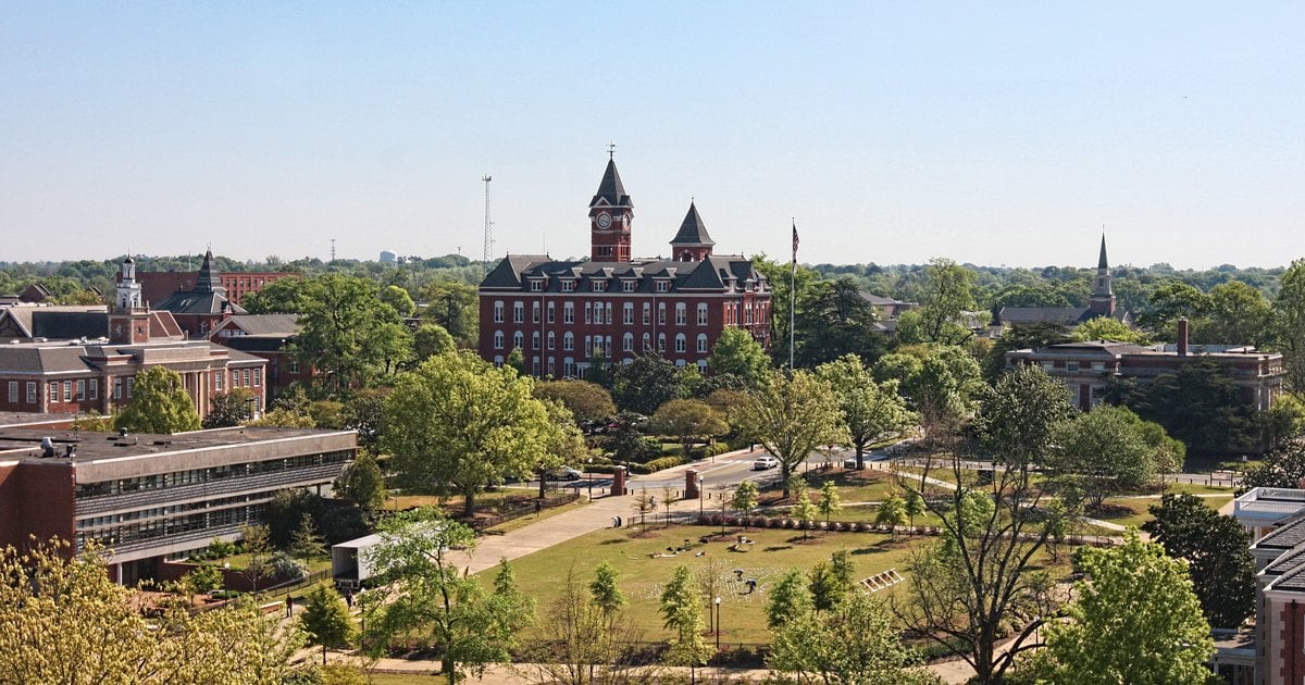 Auburn University's Samford Hall behind oak trees on a clear day in Auburn, Alabama