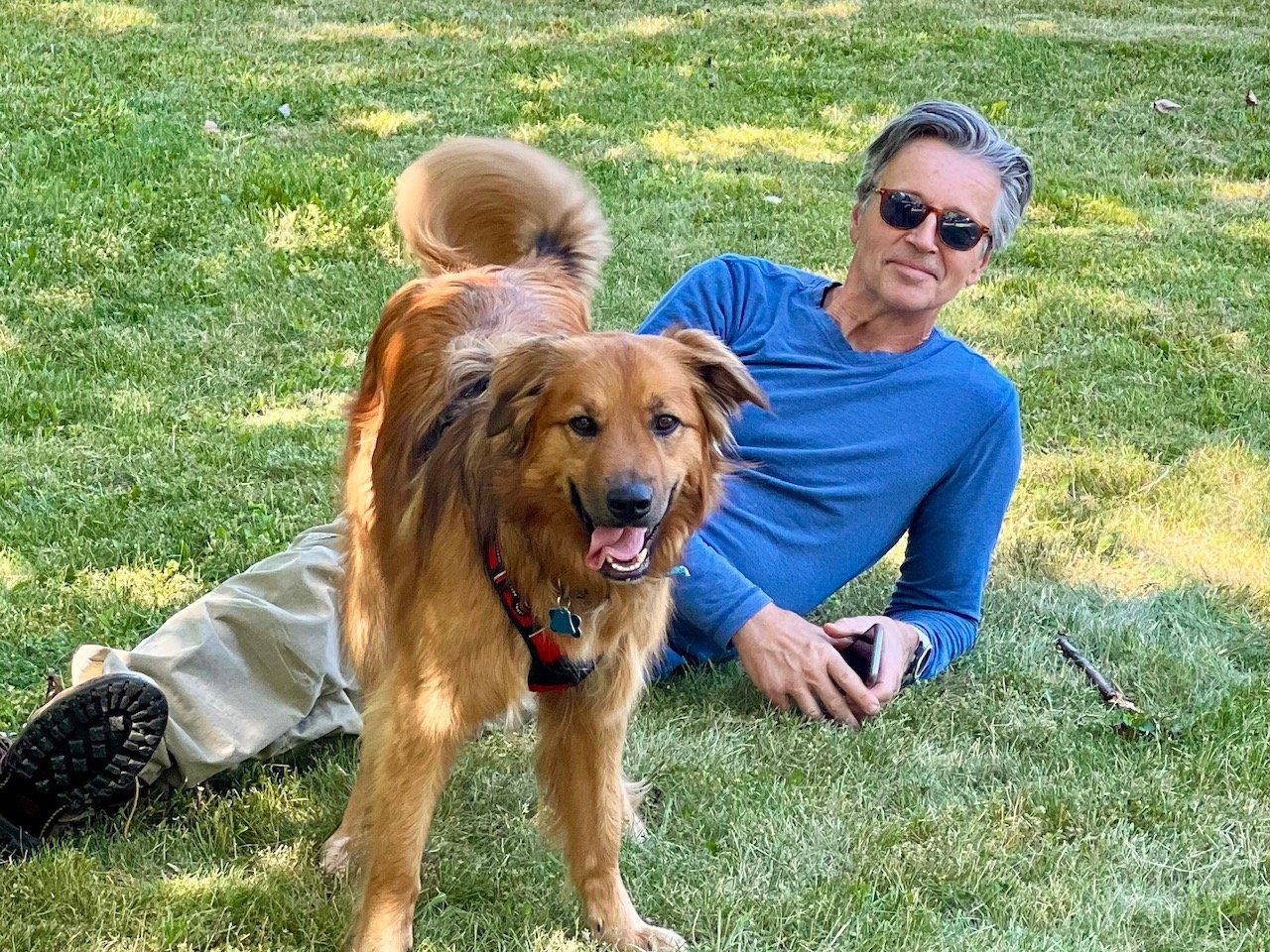 A man relaxing with a dog in Eckhart Park