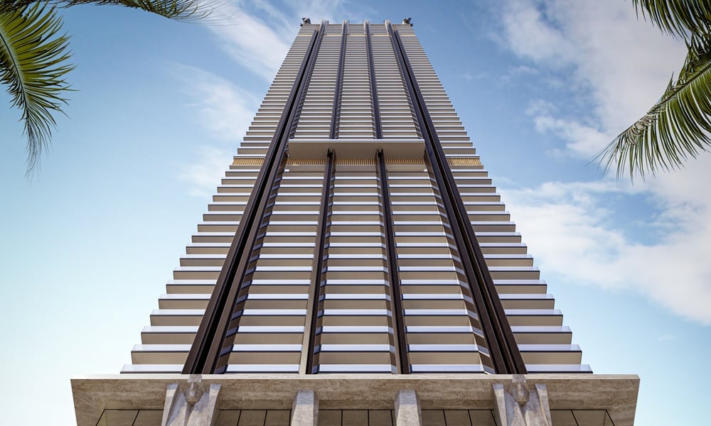 888 D & G Residences Brickell tower viewed from below, with stepped balconies and palm fronds.