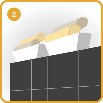 Folded towels above dark bathroom tiles, labeled 2.