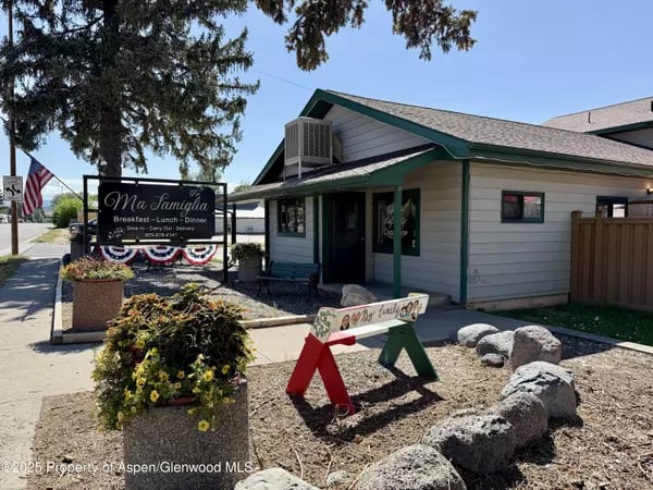 Ma Familia restaurant with green-trimmed exterior and flower planters in Meeker.