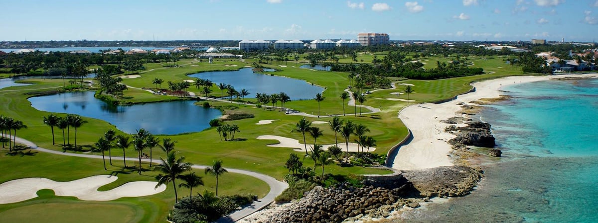 Lyford Cay golf course beside a white-sand beach and turquoise water.