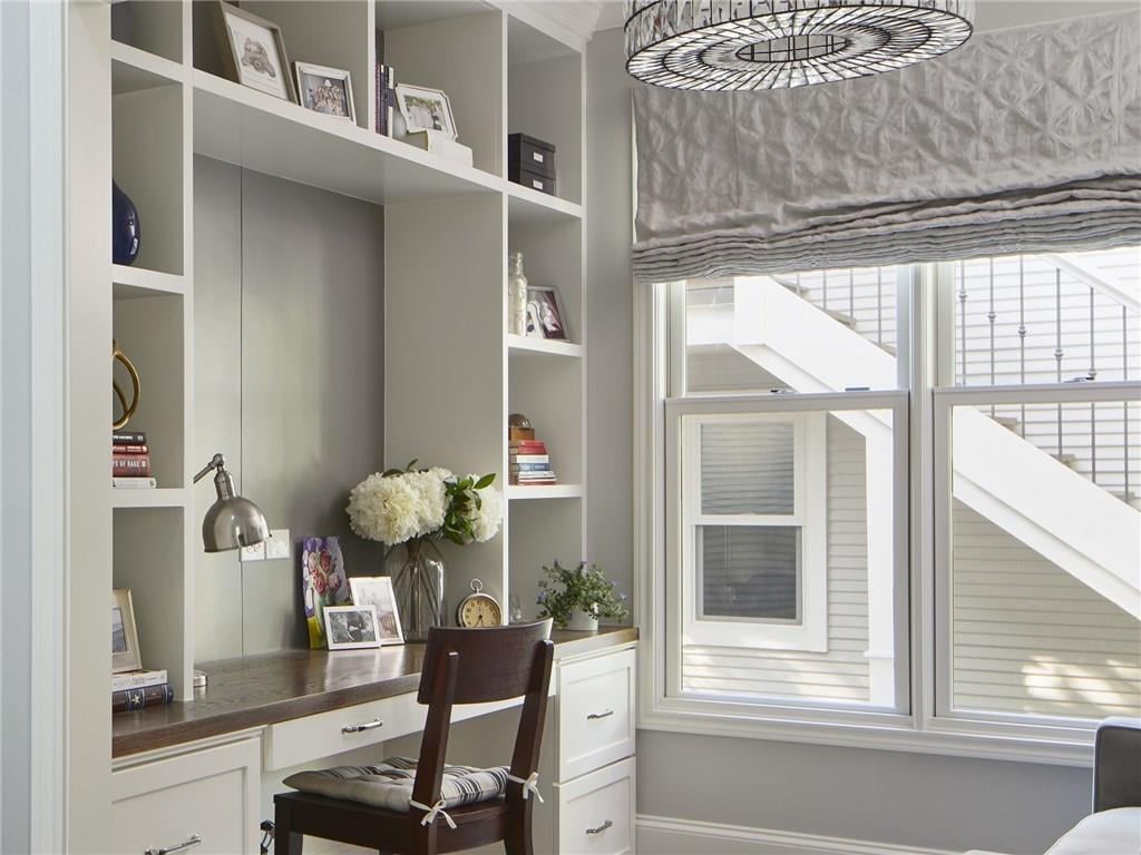 Built-in desk and shelving in the guest quarters office above the garage, overlooking the exterior staircase, in a Pemberton Heights home on Northwood Road in Austin, Texas. Guest quarters built by Oakman Building Company.
